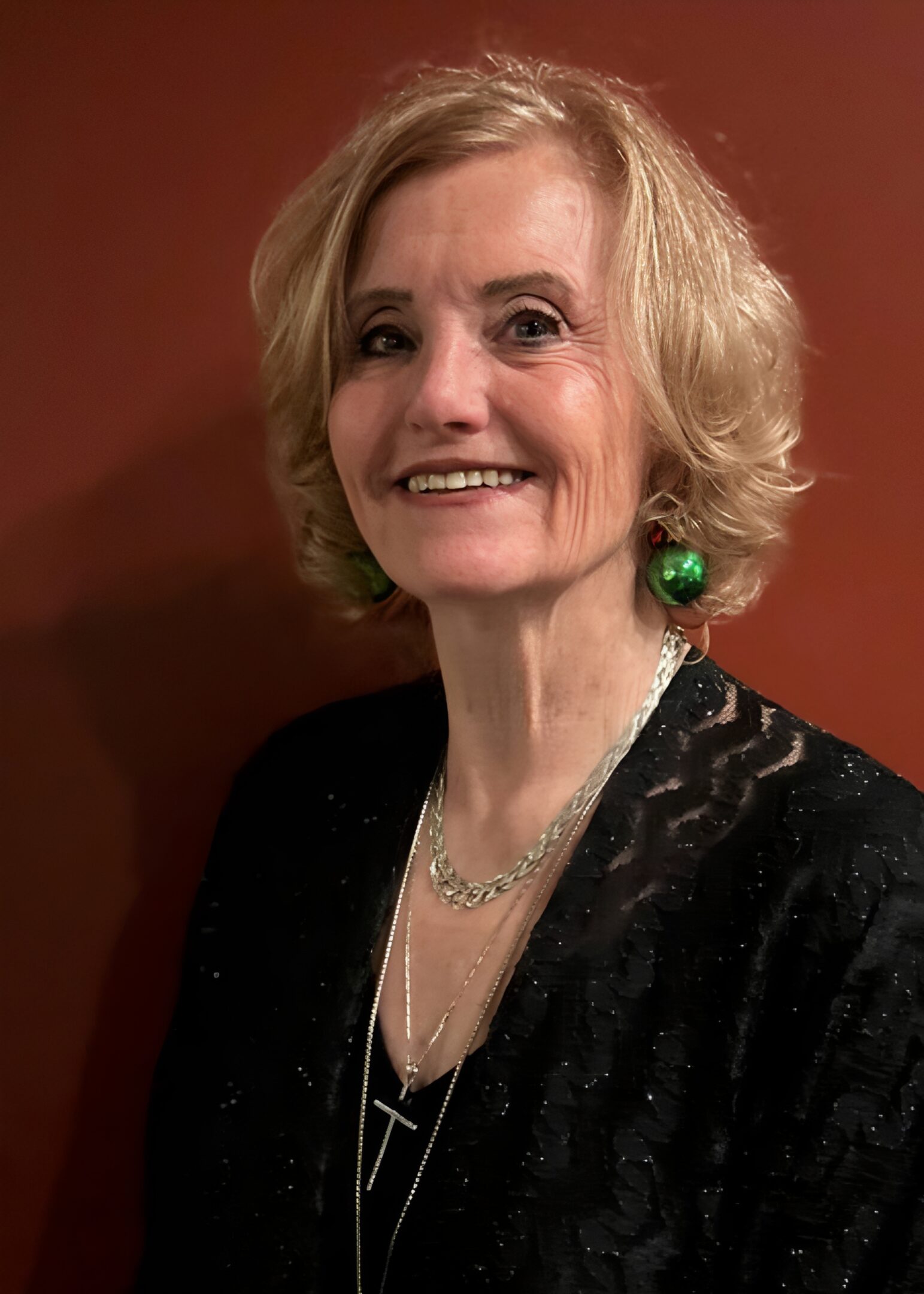 Smiling woman with short blonde hair.